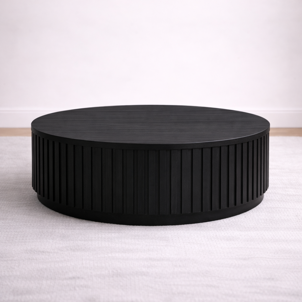 A round bespoke coffee table handcrafted from solid oak with an ebony finish featuring a slatted body built by a custom furniture maker in Nashville, TN.
