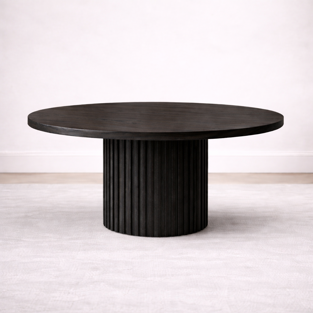 A bespoke round dining table handcrafted from solid oak with an ebony finish featuring a fluted base built by a custom furniture maker in Nashville, TN.